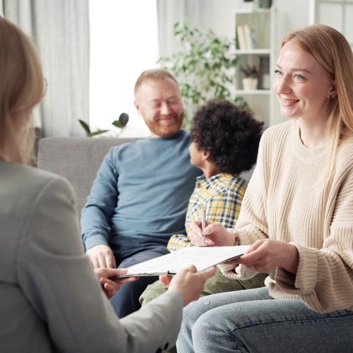 Couple signing adoption papers at home