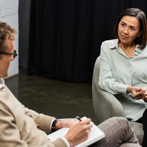 Therapist listens to woman during a private session.